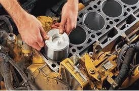 Maxodyne engine repair products being applied to a car engine.