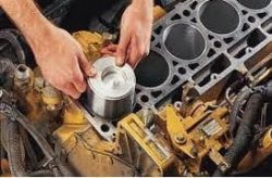 Maxodyne engine repair products being applied to a car engine.